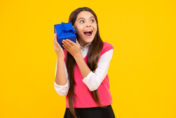 Surprised girl hold gift box. Child holding gift box in Christmas or birthday. Girl with giftbox for mothers day. Girl with a gift. Birthday, presents gift. Kid with present, festive event.