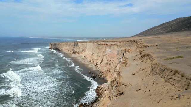 Aerial view of the coast of Eten, Lambayeque in northern Peru, with the lighthouse overlooking the Pacific Ocean and the arid coastal landscape in summer
