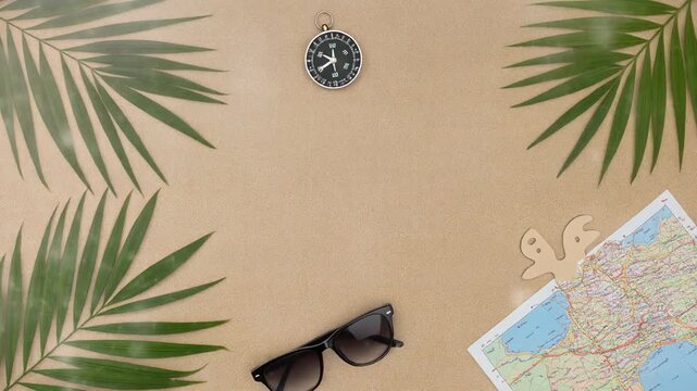 Relaxing beach vacation with palm leaves, map, sunglasses, and pocket watch on sandy surface, ideal for travel and leisure themes