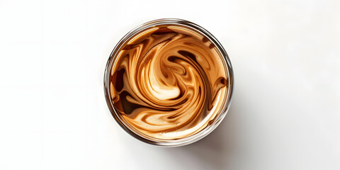 Overhead perspective shows a glass of swirling coffee, featuring abstract patterns created by creamy white and rich brown hues against a pristine white background, exhibiting a minimalist design