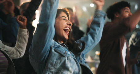 Fans, woman and cheering with celebration in pub for match goal, team victory and entertainment. Event, supporters and shouting in sports bar for soccer tournament, live broadcast and game champions © WesJVR/peopleimages.com