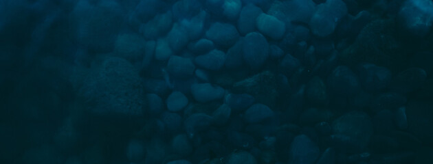 stone seabed as dark blue background