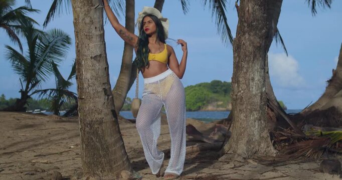 A girl in a yellow bikini having fun under the tropical sun.