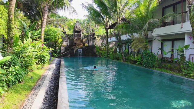Serene pool in Bali, Ubud, with lush greenery, filmed in slow motion