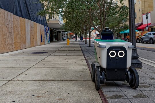 Autonomous delivery robot on city sidewalk in the United States