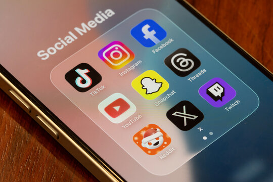 Portland, OR, USA - Dec 18, 2025: Assorted apps (TikTok, Instagram, Facebook, YouTube, Snapchat, Threads, Reddit, X, and Twitch) included in Australia's world-first teen social media ban.