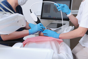 The process of digital dental scanning. The dentist examines the patient's teeth using a scanner. 3D dental scanning. Dental treatment. Horizontal.