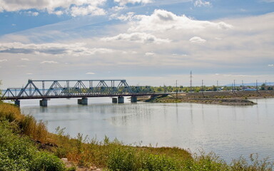 A railway bridge over the Syzran River in the city of Syzran on a sunny day