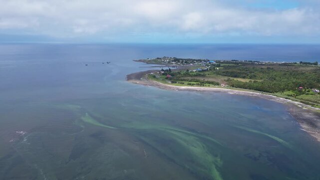 Hualaihue, Chile: Aerial view of coastal area Hualaihue, commune in Lake district of Chile on sunny day. Taken with tilt up motion