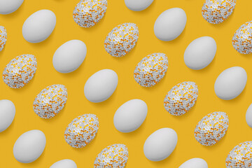 Sparkling and white easter eggs as creative pattern on yellow. Minimalist contemporary design,...