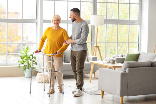 Senior woman with walker and her grandson at home