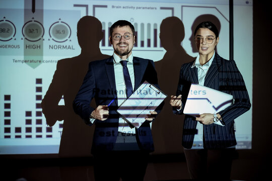 Business analysts with laptop and diagrams near projector screen in office. Data science concept - Powered by Adobe