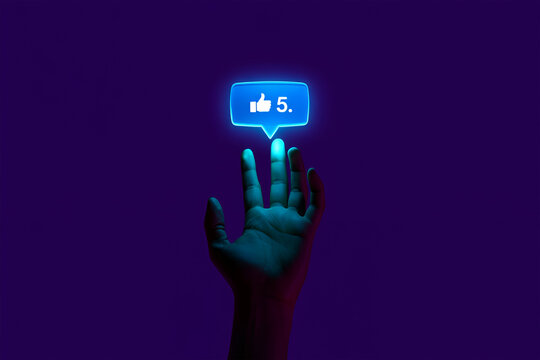 Hand reaching for glowing blue social media like notification with number five touching finger - Powered by Adobe