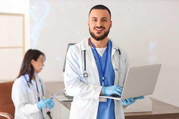 Male doctor analyzing scientific data on laptop in laboratory