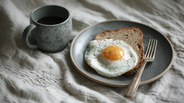 Simple Breakfast with Fried Egg and Coffee on Rustic Linen Background