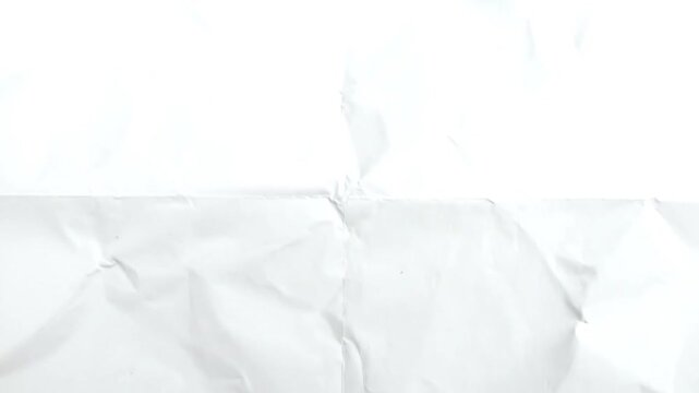 A close-up shot of a white sheet of paper that has been folded into four parts with creases