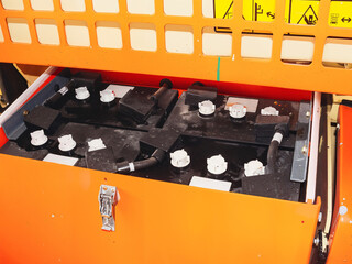 Close-up view of a forklift battery compartment with multiple cells and connectors