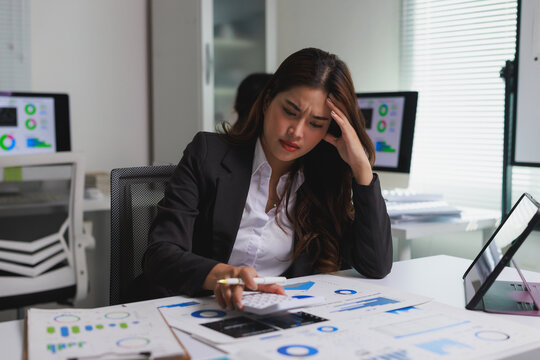 Stressed businesswoman calculating expenses facing financial problems