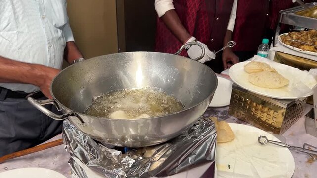 Frying live puri at a Bengali wedding in India.