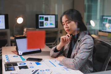 Woman analyzing business data with charts and graphs