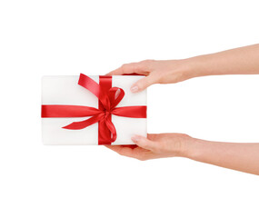 Naklejka premium Female hand holding or present white gift box with red silk bow isolated on white background with clipping path. Design element.
