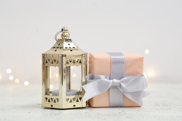 Obraz premium Gift box with Muslim lamp for Ramadan on white table