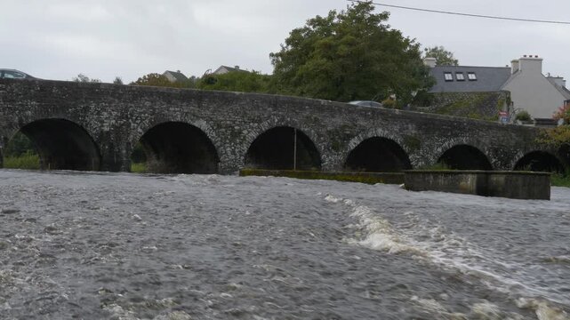 Historic stone bridge over River Inagh cascades in Ennistymon, Ireland