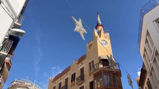 Christmas in Sitges, Catalu&ntilde;a, Spain - People shopping on sunny Casa Bartomeu Carbonell street in Sitges, Spain during Christmas holidays