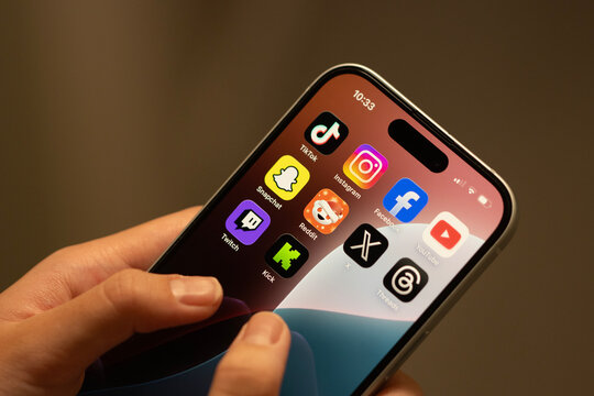 Portland, OR, USA - Dec 18, 2025: Apps (TikTok, Instagram, Facebook, YouTube, Snapchat, Reddit, X, Threads, Twitch and Kick) included in Australia's world-first teen social media ban on an iPhone.