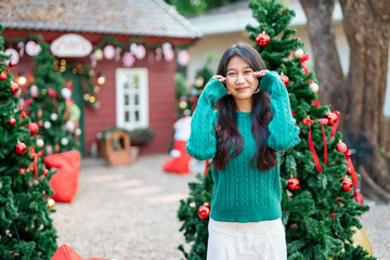 During Christmas time, a happy young woman enjoys a large Christmas gift.