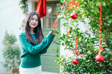 During Christmas time, a happy young woman enjoys a large Christmas gift.