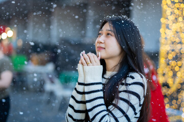 Beautiful young woman spinning in the winter snow 