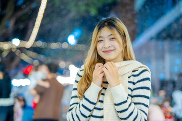 Beautiful young woman spinning in the winter snow 