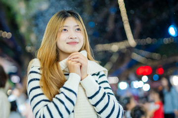 Beautiful young woman spinning in the winter snow 