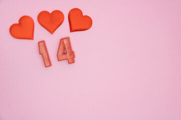 Three hearts on a pink postcard. The numbers 14 are red. A Valentine's Day card.