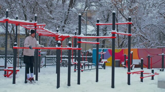Young Man Training on Outdoor Sports Playground &ndash; Push-Ups, Abs Workout and Parallel Bars Street Fitness