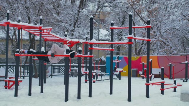 Young Man Training on Outdoor Sports Playground &ndash; Push-Ups, Abs Workout and Parallel Bars Street Fitness