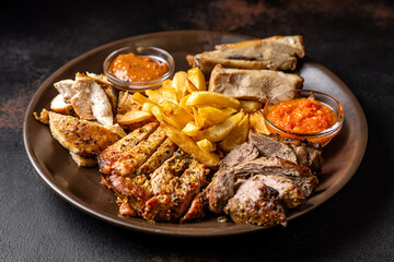 Mixed grilled meat platter with potato wedges