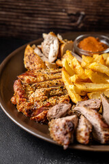 Grilled meat platter with potato wedges