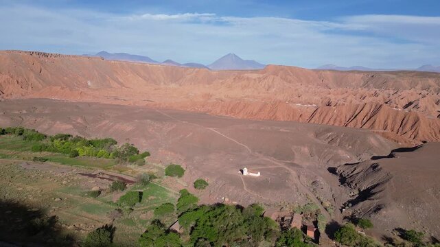 San Pedro de Atacama, Chile: Aerial footage of San Isidro church in the middle of Catarpe valley, San Pedro de Atacama, Chile. Taken with forward and tilt up motion showing the Licancabur volcano