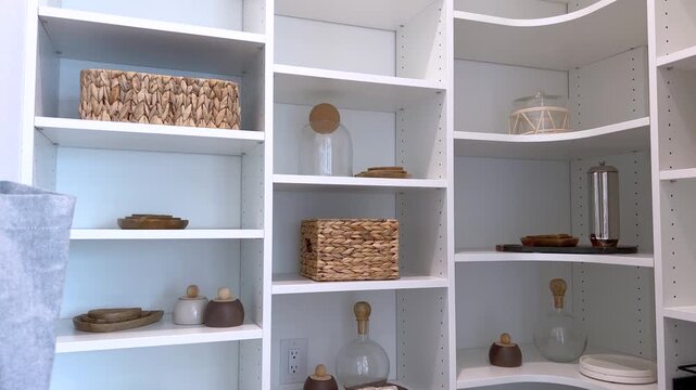 Pantry shelving with baskets and neatly arranged kitchen items