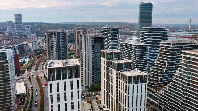 Aerial drone view of the Belgrade Waterfront skyline showcasing luxury residential towers, modern urban development, and the Kula Belgrade tower dominating the background