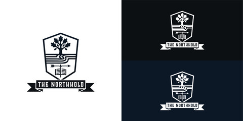 The modern black shield crest features a sturdy tree, winding paths, and an arrow positioned above an open book. This design successfully blends a bold, simplistic aesthetic with heritage.