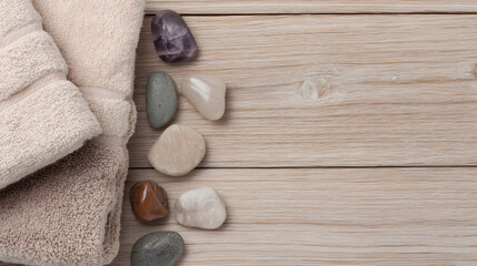 Spa Relaxation: Soft, inviting towels and smooth stones arranged on a warm, wooden surface, evoking a sense of tranquility and spa-like relaxation.