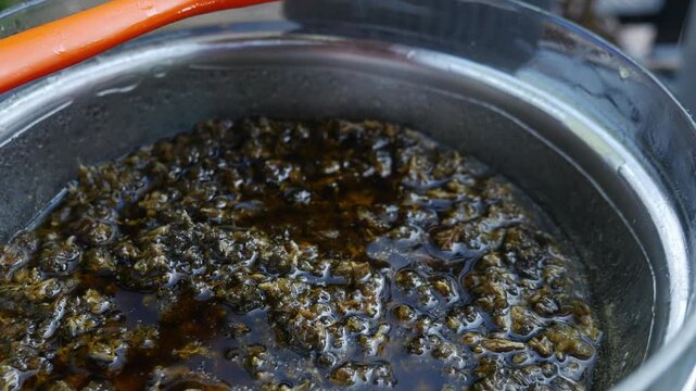Boiling Cannabis in Butter Double Boiler: Marijuana Infusion Cooking Process Bubbles Steam Cannabutter Making Method