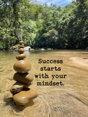 Balanced stone stack in a clear river with motivational quote &ldquo;Success starts with your mindset,&rdquo; symbolizing focus, mindfulness, personal growth, and inner peace in nature.