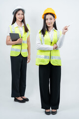 Vertical photo showing Asian female engineers reviewing data on a tablet, highlighting AI technology, smart construction management, professional teamwork, and modern industrial safety concepts.