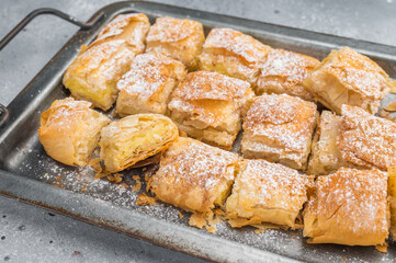 Traditional bougatsa Greek  custard pastry with creamy milk filling flaky filo layers and powdered sugar bakery dessert