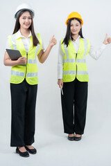 Vertical photo featuring Asian female engineers on site using digital tablets, highlighting AI technology adoption, smart construction workflows, women leadership, and modern safety standards.