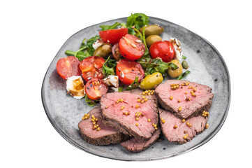 Sliced roast beef medium rare served with fresh arugula salad tomatoes olives and cheese on light background top view